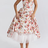 Red rose print vintage fit and flare dress styled for a garden party, featuring a classic day dress design with a defined waist, short sleeves, and a knee-length hemline.