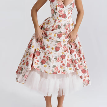 Red rose print vintage fit and flare dress styled for a garden party, featuring a classic day dress design with a defined waist, short sleeves, and a knee-length hemline.