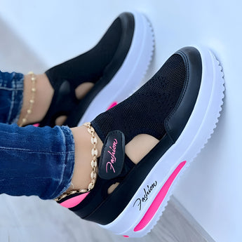 Red slip-on platform sneakers with breathable cut-out design and chain detail, shown in Nero color variant, size 42, worn on a human leg.
