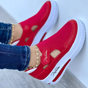 Red slip-on platform sneakers with breathable cut-out design and gold chain detail, shown in size 42.