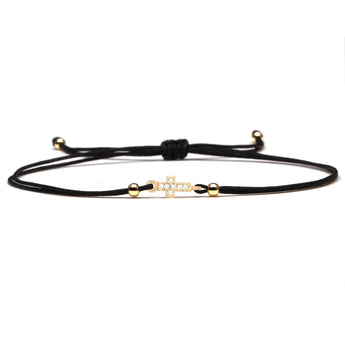 Red string bracelet with a gold charm, adjustable design, displayed with a black string option as a lucky and spiritual gift.