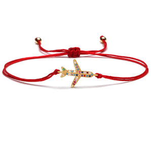 Red string bracelet with a starfish charm adorned with multicolor crystals, adjustable beach-themed fashion accessory.
