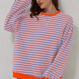 Red and white striped long sleeve blouse with a crew neck and button cuffs, shown in an XL size and styled in a casual fashion setting.