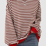 
A red and white striped long sleeve crew neck blouse with button cuffs, featuring a tailored fit and soft fabric, shown in an XL size.