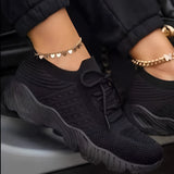 Red women's breathable mesh sneakers, lightweight athletic shoes in Nero color, size 43, displayed in a setting with accessories like sunglasses and body jewelry.