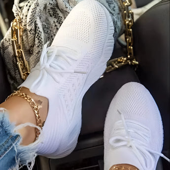 White breathable mesh sneakers for women, size 43, featuring a lightweight athletic design with black accents, shown on a model's foot.