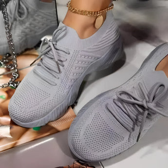 Gray women's breathable mesh sneakers, lightweight and stylish, designed for athletic activities and walking.