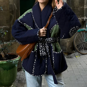 Reversible navy blue quilted kimono jacket featuring a stylish urban boho design, displayed on a model. The jacket has long sleeves and a unique quilted texture that combines traditional and modern fashion elements.