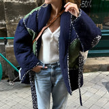 Reversible navy blue quilted kimono jacket featuring urban boho style with long sleeves, a collar, and patterned textile design.