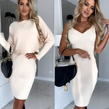 Brown ribbed long sleeve mini dress with a belted waist, modeled by a smiling woman wearing white shoes, showcasing fall fashion style.