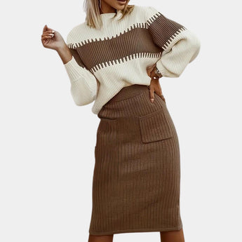 Ribbed knit dress and fringe sweater set worn by a person, paired with a white textured bag. The outfit features a day dress design with long sleeves and a fitted waist.
