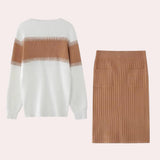 Beige ribbed knit dress paired with a fringe sweater, styled with a white textured bag.