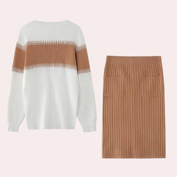 Beige ribbed knit dress paired with a fringe sweater, styled with a white textured bag.