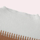 Ribbed knit dress paired with a fringe sweater, accompanied by a white textured bag, showcasing a stylish and comfortable fashion ensemble.