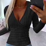 Ribbed V-neck black slim fit blouse with button detail, featuring long sleeves and tailored to a 2XL size, worn by a model pairing it with jeans.