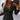 Ribbed V-neck black slim fit blouse with button detail, featuring long sleeves and tailored to a 2XL size, worn by a model pairing it with jeans.
