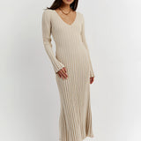 Ribbed V-neck cream maxi sweater dress with long sleeves, worn by a person standing, showcasing fall fashion style.