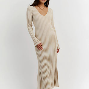 Ribbed V-neck cream maxi sweater dress with long sleeves, worn by a person standing, showcasing fall fashion style.