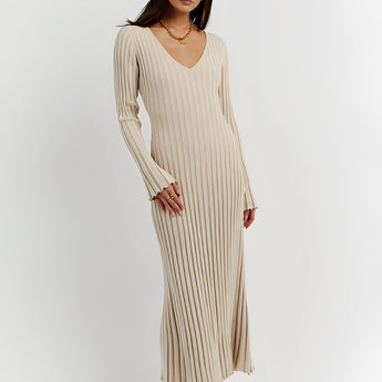 Ribbed V-neck cream maxi sweater dress with long sleeves, worn by a person standing, showcasing fall fashion style.