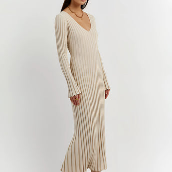 
A ribbed cream maxi sweater dress featuring a V-neckline and long sleeves, showcasing fall fashion with its elegant design.