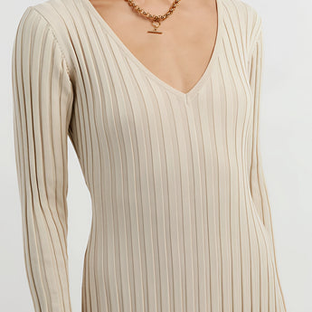 Ribbed V-Neck Cream Maxi Sweater Dress showcasing long sleeves and a form-fitting silhouette, emphasizing the shoulder and arm details. The dress is styled for fall fashion and is displayed in a neutral cream color, resembling a blend of white and grey tones.