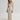 Ribbed V-neck cream maxi sweater dress with long sleeves, featuring a fitted waist and a flowing silhouette reaching down to the knees, perfect for fall fashion.