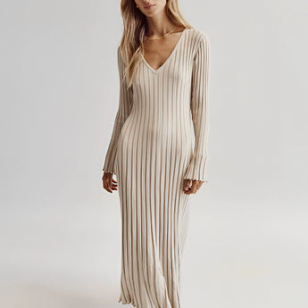 Ribbed V-neck cream maxi sweater dress with long sleeves, featuring a fitted waist and a flowing silhouette reaching down to the knees, perfect for fall fashion.