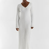 Ribbed V-neck cream maxi sweater dress with long sleeves, worn by a fashion model showcasing fall fashion, highlighting the shoulder, neck, and waist details.