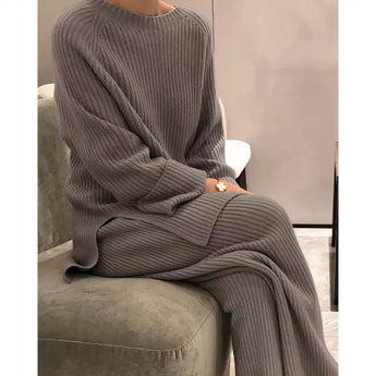 Ribbed women's loungewear set in a cozy pastel coffee color, featuring a soft knit top with long sleeves and a matching pair of pants. The outfit is comfortable and ideal for lounging, with a relaxed fit and 3XL size. The subtle ribbing and neutral tone offer a stylish and warm look.
