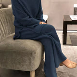 Soft knit ribbed women's loungewear set in pastel blue, featuring a long-sleeve top and matching pants, in size 3XL, displayed on a wooden surface.