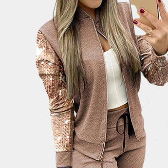 Rose gold velvet tracksuit with sequin detail for women, showcasing luxurious activewear design, featuring long sleeves and a fitted waist in a beige color, displayed in size XL.
