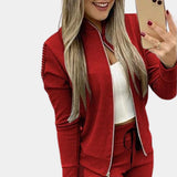 
A red rose gold velvet tracksuit with sequin detail, designed for women's luxury activewear, shown in an XL size. The tracksuit features a high collar, long sleeves, and an elegant design accentuating the waist.