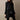 
A black, double-breasted women's designer trench coat in size 3XL, featuring a classic collar and long sleeves.
