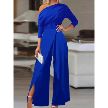A woman wearing a royal blue one-shoulder wide-leg jumpsuit in size 3XL, suitable for formal cocktail attire.