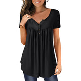 A woman wearing a royal blue pleated scoop neck blouse, smiling with long hair, showing shoulders and arms, styled as a casual summer top.