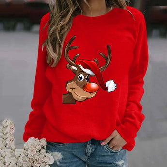 A woman wearing a red Rudolph Reindeer Christmas sweatshirt, styled with casual jeans and sunglasses, showcasing a festive look.