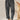 Gray high-waisted women's pleated pants in vintage style, made from corduroy fabric, worn by a person standing. The pants are designed with a focus on the waist and feature a relaxed fit around the thigh and knee areas.