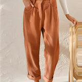 Rust orange high-waisted women's pleated pants made from corduroy fabric, styled in a vintage fashion, shown in 3XL size.