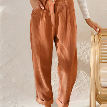 Rust orange high-waisted women's pleated pants made from corduroy fabric, styled in a vintage fashion, shown in 3XL size.