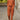 Orange linen jumpsuit set in plus size 3XL, featuring a stylish design with a collared neckline, long sleeves, and a tailored waist, modeled by a fashion model.