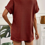 Rust red ribbed knit top displayed on a mannequin, showcasing its short sleeves and rounded neckline, ideal for casual summer wear.