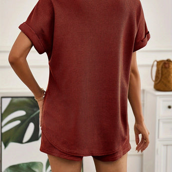 Rust red ribbed knit top displayed on a mannequin, showcasing its short sleeves and rounded neckline, ideal for casual summer wear.