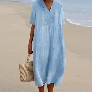 Sea blue linen maxi dress with a V-neck and short sleeves, designed as casual lightweight beachwear. The dress features a loose fit around the waist, ideal for summer outings, and is shown in a vibrant electric blue color, size 2XL.