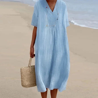 Sea blue linen maxi dress with a V-neck and short sleeves, designed as casual lightweight beachwear. The dress features a loose fit around the waist, ideal for summer outings, and is shown in a vibrant electric blue color, size 2XL.