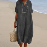 A black linen maxi dress featuring a V-neck design and short sleeves, styled for casual beachwear in a lightweight fabric.