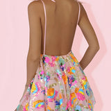 Sparkly festival outfit featuring a sequin skater skirt and a backless halter top modeled on a human body.