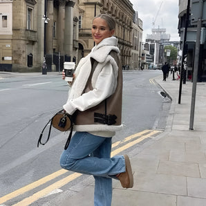 Sherpa Fleece Vest with Buckle worn by a woman on a city sidewalk, showcasing streetwear style with cool and casual elements.