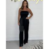 Shimmery silver strapless metallic jumpsuit designed for evening party wear, shown in Nero color and size 4XL, featuring a model with a smiling expression.
