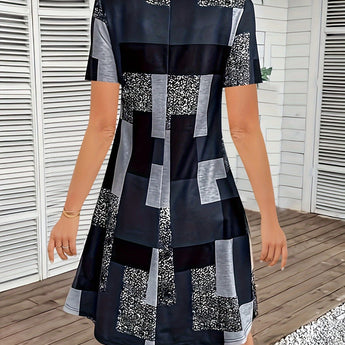 A stylish short summer dress featuring an asymmetric geometric pattern, designed as streetwear with a one-piece garment style. The dress highlights shoulder and neck details, includes short sleeves, and is fitted at the waist, perfectly suited for daytime outings.