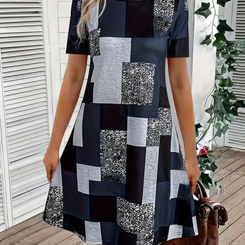 Short geometric summer dress with an asymmetric pattern, featuring a white and black design, sleeveless shoulder style, and a round neck.